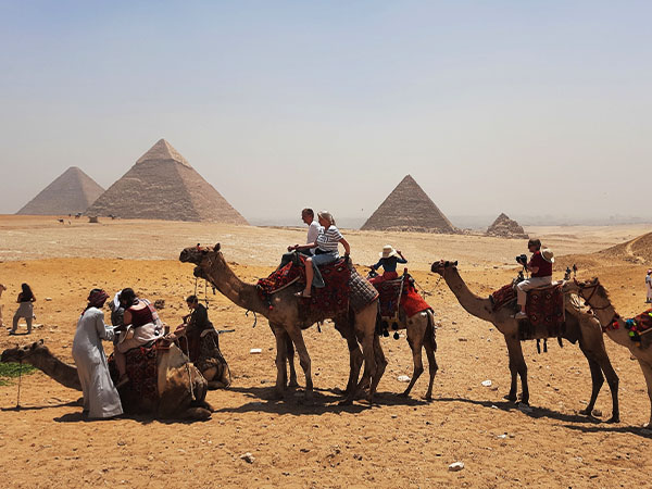 The camel riding by the Pyramids